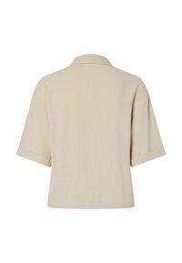 Chemise beige à manches courtes avec col, vue de dos, avec une coupe carrée et un design simple.
