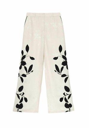 Pantalon large crème avec motifs floraux noirs en forme de feuilles sur le bas des jambes, poches latérales et passants de ceinture à la taille.