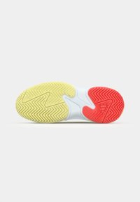 Shoe sole featuring a wavy pattern, with yellow, white, and red sections; rubber material; textured for traction and stability.