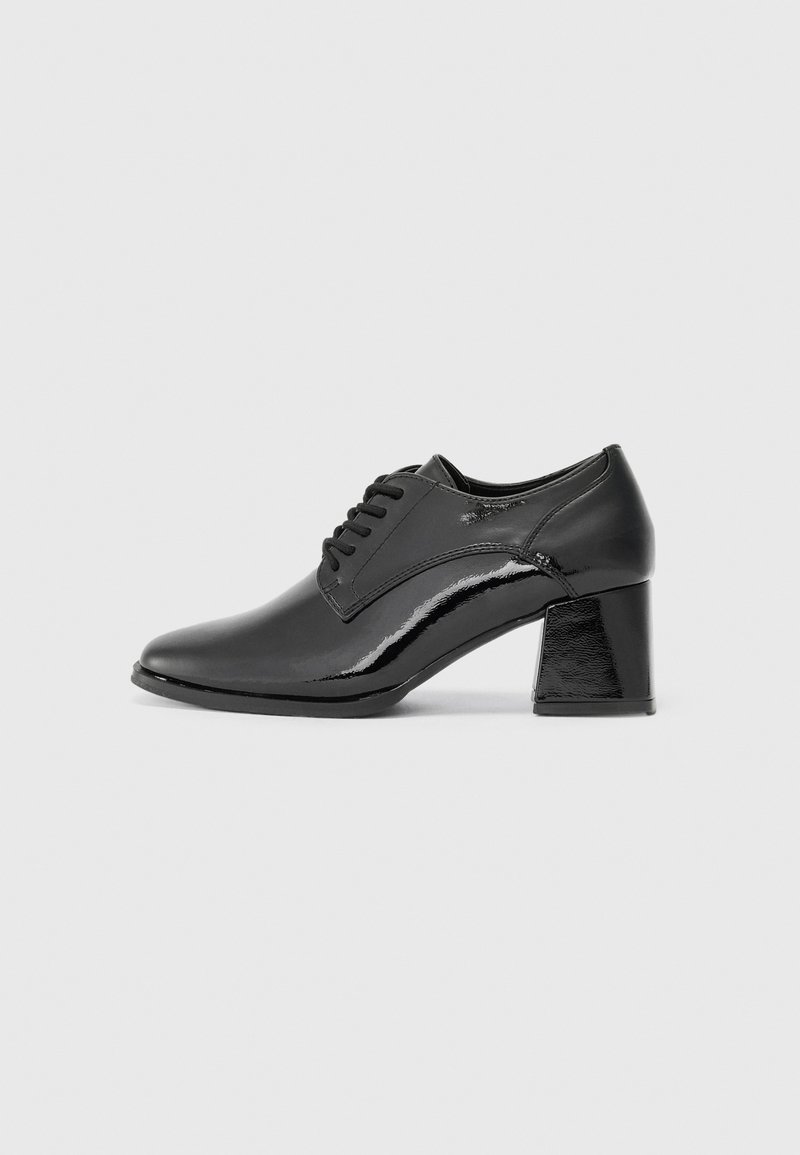 Black patent leather shoes with a rounded toe, lace-up design, and a chunky rectangular heel. Smooth texture with a glossy finish.