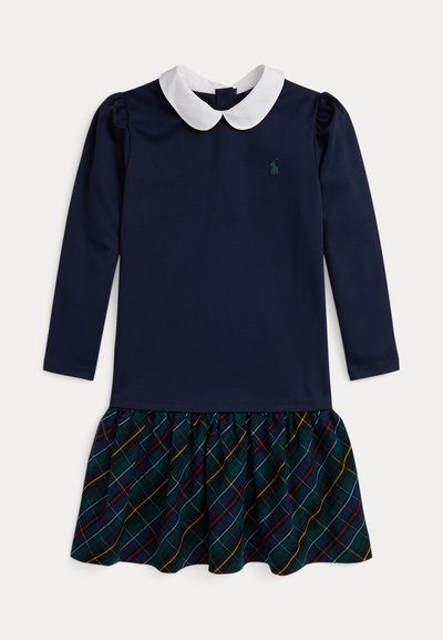 Ilgų rankovių suknelė su mėlynu viršumi, baltu apykakle ir langiniu sijonu, kuriame vyrauja žalia, raudona ir geltona spalvos. Minkšta medžiaga su susirinkusia apatine dalimi.