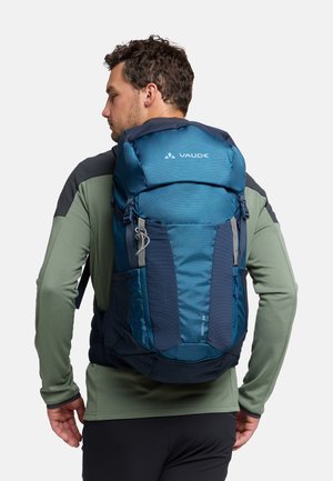 Zaino Vaude di colore blu scuro con pannelli texture e lisci, dettagli riflettenti, spallacci regolabili e tasche laterali per riporre oggetti.
