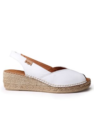 Espadrille compensée en cuir blanc avec bout ouvert, bride arrière et semelle tressée en jute sur fond blanc.