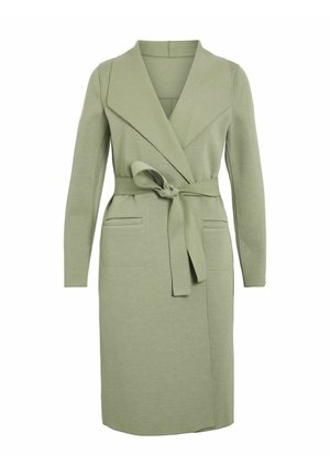 Olive green wrap dress in soft fabric, with long sleeves, shawl collar, tie belt, and two front pockets.