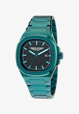 Montre-bracelet en métal vert avec cadran noir texturé, index et aiguilles luminescents, affichage de la date à 3 heures, et logo Aston Martin sous 12 heures.