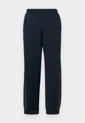 Navy sweatpants with a soft texture, tapered cuffs, and mesh side panels. Elastic waistband for comfort and casual fit.