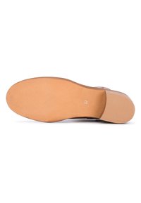 Suela de zapato marrón con una superficie suave y texturizada que presenta un agarre con patrón. Tamaño marcado como 37.
