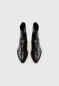 Cizme negre din piele până la gleznă, cu vârf ascuțit, textură netedă, fermoar lateral și design unghiular. Stil minimalist, fără modele vizibile.