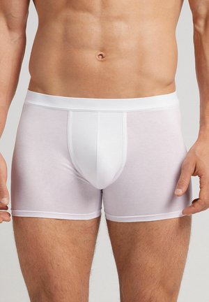Weiße Baumwoll-Boxershorts mit engem Sitz, nahtloser Vorderseite, elastischem Bund und glatter Textur.