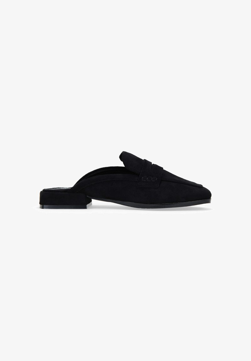 Zapato negro de ante tipo slip-on con tacón plano. Presenta una punta afilada y un diseño de parte superior doblada, proporcionando una textura suave y un perfil elegante.