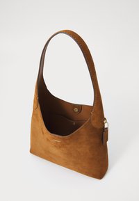 Brown suede handbag with a shoulder strap, featuring a spacious interior and a gold snap closure. Simple and elegant design on a light background.