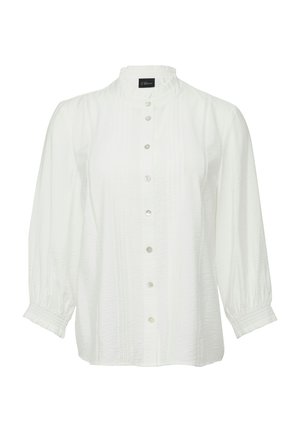 Blusa bianca con maniche lunghe a palloncino, colletto rialzato e chiusura con bottoni. Presenta pieghe e una texture sottile.