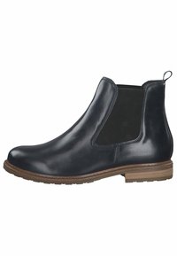 Botte Chelsea en cuir noir avec panneaux latéraux élastiques, embout arrondi et semelle marron texturée. Dispose d'une languette au talon pour un enfilage facile.