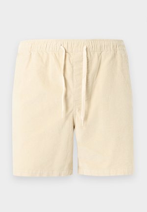 Svetlo bež kratke hlače iz korduroja z elastičnim pasom in zaponko s trakom v enaki barvi, dolžine do sredine stegna, z ravnim sprednjim delom.