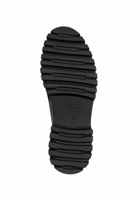 Semelle de chaussure en caoutchouc noir avec des rainures horizontales profondes, nom de marque "Tamaris" et taille 37 visible au centre.