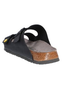 Black leather sandal with a curved design, featuring a cork footbed and rubber sole. Includes two adjustable straps with a yellow button.