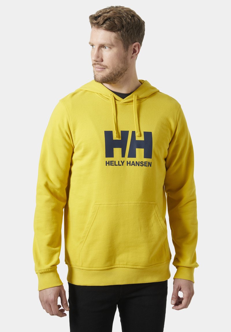 Żółta bluza z kapturem, z kieszenią z przodu i granatowym logo "HH". Wyposażona w sznurki do ściągania kaptura oraz ściągacze na mankietach. Miękka tekstura materiału.