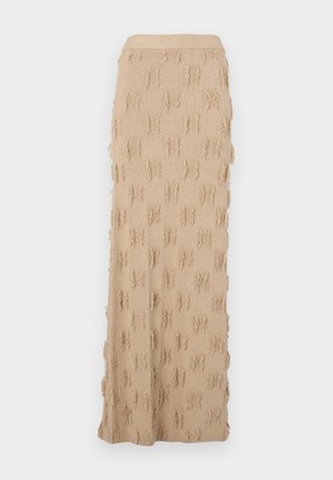 Beige knitted maxi skirt featuring a textured pattern with frayed accents throughout and a ribbed waistband. Smooth and flexible material.