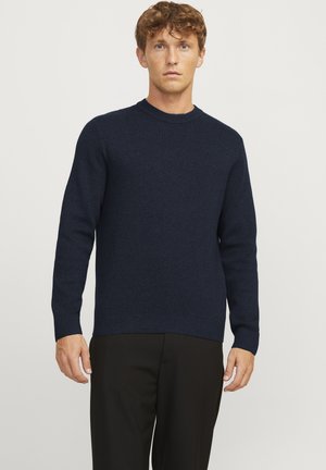 Navy blue knitted sweater with a crew neckline, long sleeves, and ribbed cuffs and hem; textured fabric with a subtle pattern.