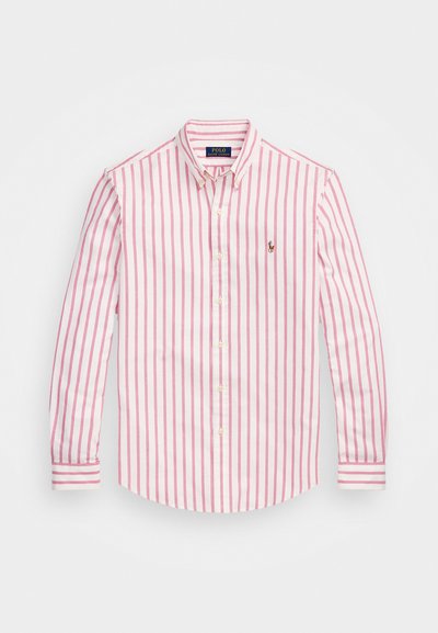 Juostelėta balta ir rožinė marškiniai su ilgomis rankovėmis, pagaminti iš medvilnės, su mygtukų rankogaliais, maža logotipas ant krūtinės, klasikinio apykaklės dizaino.