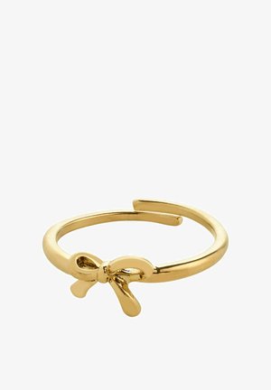 Bague en métal doré avec un bandeau lisse et un accent en forme de nœud décoratif à l'avant. La surface est brillante avec une finition polie.