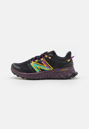Black and purple running shoe with teal and yellow logo, purple laces, and textured sole labeled Fresh Foam, side view on white background.