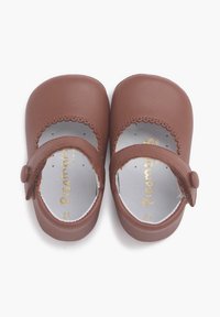 Brown leather toddler shoes with a rounded toe, scalloped edges, and a strap with a button closure. Interior features a silver insole.