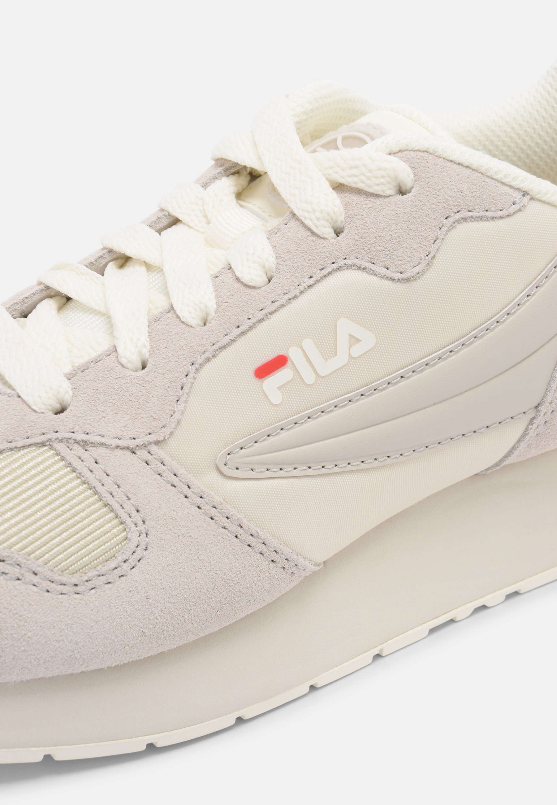 beige fila trainers