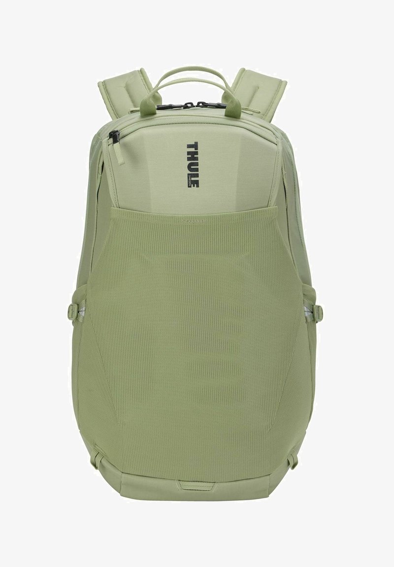Sac à dos Thule vert clair avec bretelles rembourrées, poignée supérieure, compartiments zippés et panneau avant en mesh respirant.