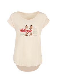 Cream-colored t-shirt with short rolled sleeves. Features a Kellogg's logo and four childhood photos printed on the front. Soft, casual design.