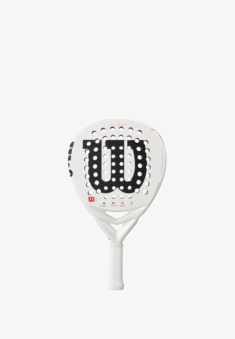 Wilson paddle with a white body and a black logo. Circular perforations across the face, textured grip handle, and triangular cutouts near the neck.