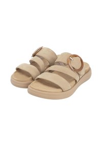 Sandales en daim beige avec deux brides avant et un grand accent circulaire. Présentent une semelle intérieure douce et texturée ainsi qu'une semelle de couleur claire.