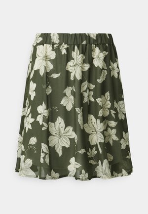 A-lijn rok met elastische tailleband, donkergroene basis en grote crèmekleurige bloemenprint over de stof.