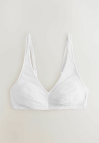Hvid trådløs blød skål-bh med justerbare tynde stropper, sømløs design og V-formet udskæring.