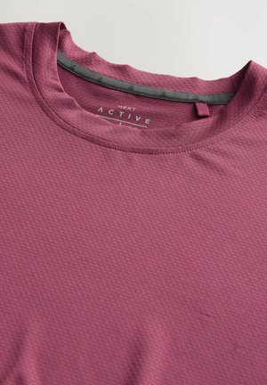 Maroon activewear t-shirt with a textured surface, round neckline, and a gray trim on the inner neck. Features a small loop for hanging.