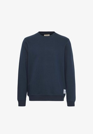 Mørkeblå sweatshirt med rund hals, ribbede mansjetter og hem. Laget av en myk materiale, med en liten merkeetikett på siden.