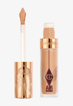 Liquid foundation in a clear glass bottle with gold accents; features a pump dispenser. Includes a matching applicator wand in a gold tube.