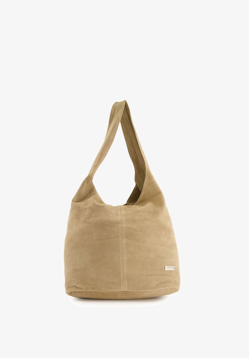Beige suede shoulder bag with a rounded shape, wide strap, and a stitched seam detail. Minimalist design with a small logo tag.