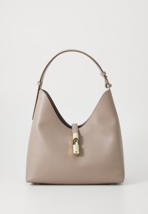 Beige leather handbag with a curved shape, featuring a gold-tone clasp and a single adjustable shoulder strap. Smooth texture, minimal design.