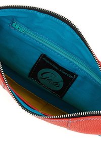 Borsa in pelle rossa con chiusura a zip. L'interno presenta un rivestimento turchese, una piccola tasca con zip e sezioni colorate in senape e rosa.