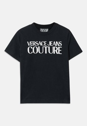 Black cotton t-shirt with short sleeves, featuring large white text that reads "VERSACE JEANS COUTURE" across the chest.