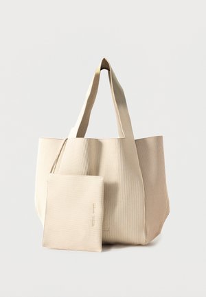 Beige large tote bag with ribbed texture and matching detachable pouch with zipper in front on a plain background.