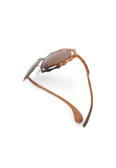 Brown-tinted sunglasses with a distinctive, open-frame design. Features a combination of metal and plastic, with flexible arms and nose pads.