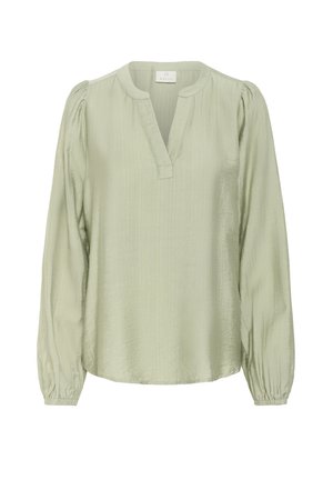 Light green blouse made of textured fabric, with a V-neckline and long puff sleeves, featuring elastic cuffs and a relaxed fit.