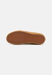 Rubber sole with a diamond-patterned texture in brown, featuring a smooth edge and a slightly raised heel section for stability.