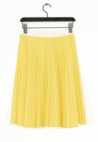 Pleated skirt with a yellow fabric and a white waistband, featuring a flowy design and textured finish, hanging on a black hanger.