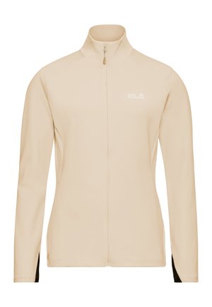 Veste de sport beige avec un col montant, une fermeture éclair intégrale, des manches longues et des accents noirs aux poignets, arborant un logo discret sur la poitrine.