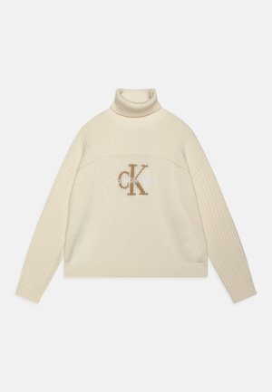 Maglione a collo alto in un modello a coste con un grande logo ricamato "CK" sul petto. Texture morbida e design dalla vestibilità ampia.