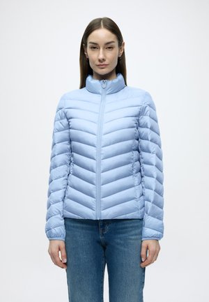 Light blue puffer jacket with vertical quilted pattern, full zip, high collar, and long sleeves. Worn over blue jeans.