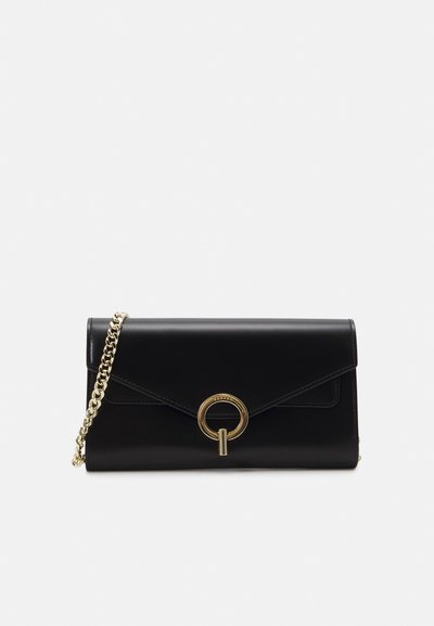 Black leather clutch bag with a metallic gold chain strap, featuring a front flap, circular hardware detail, and sleek, minimalist design.